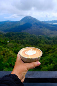 Cropped hand of man holding ice cream