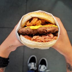 Low section of person holding burger