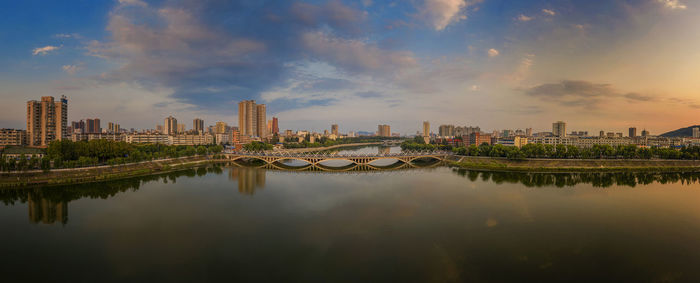 The reflection of water under the dramatic sky on urban buildings