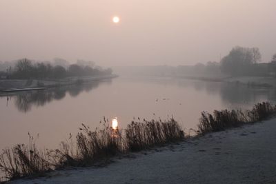 Scenic view of lake against sky during sunset