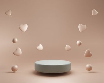 3d podium display background. beige with levitating hearts. beauty cosmetic product presentation. 