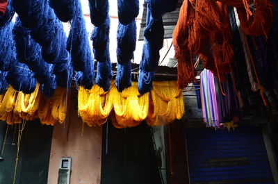 Low angle view of illuminated lanterns hanging by building