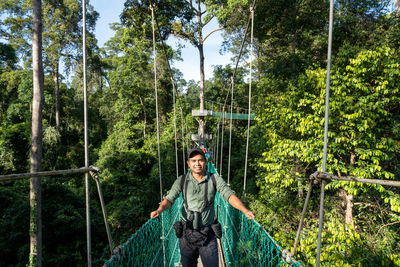 Full length of woman standing on footbridge