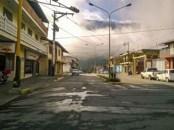 Empty road against sky in city