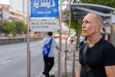 Man standing at bus stop