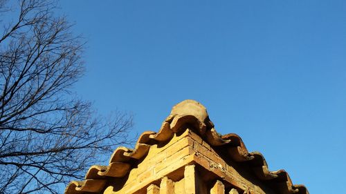 Low angle view of built structure against clear blue sky