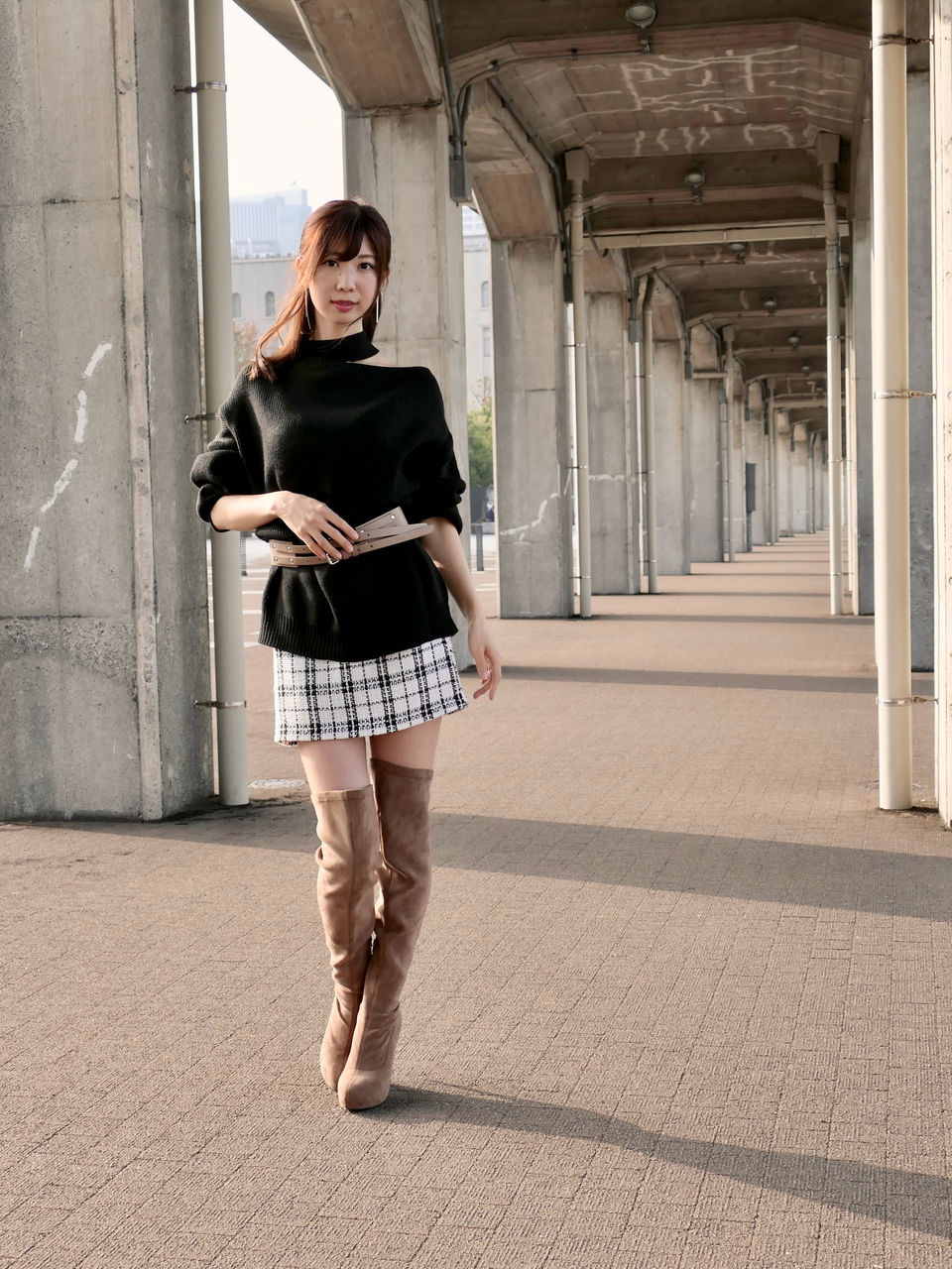 one person, full length, architecture, adult, fashion, spring, women, clothing, young adult, skirt, front view, portrait, built structure, day, footwear, standing, casual clothing, dress, person, photo shoot, wireless technology, lifestyles, hairstyle, city, smiling, emotion, looking at camera, outdoors, female, brown hair