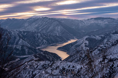 Scenic view of snowcapped mountains against sky during sunset