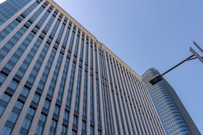 Low angle view of modern building against clear blue sky