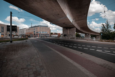 Empty road with bridge in background