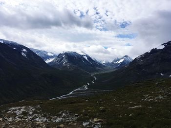 Scenic view of mountains against cloudy sky