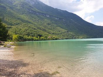 Scenic view of lake and mountains against sky