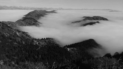 Scenic view of sea and mountains against sky