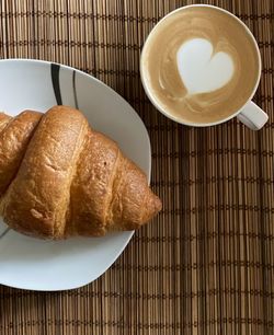 Breakfast with coffee and croissant 