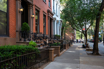 Footpath amidst buildings in city