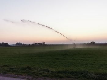 Scenic view of field against sky during sunset