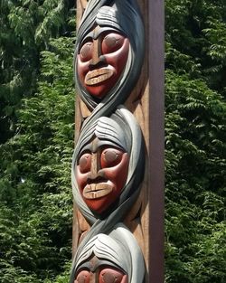 Portrait of person wearing hat against trees
