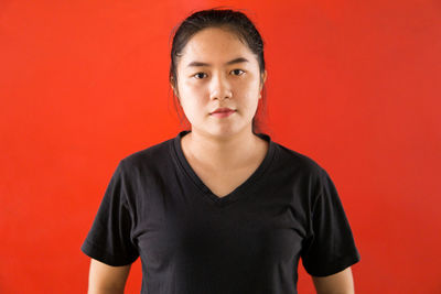 Portrait of young man against yellow background