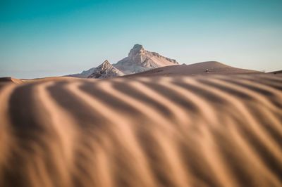 Scenic view of arid landscape against clear sky