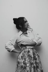 Woman looking away against white background