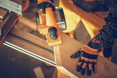 Midsection of man working at workshop