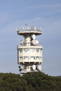 Low angle view of communications tower against sky