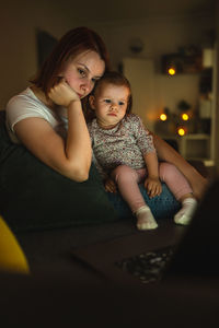 Portrait of young woman sitting at home