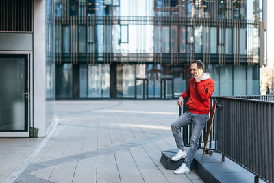 Attractive man calling by the cell phone. skateboarder stopped to make a phone call. urban concept