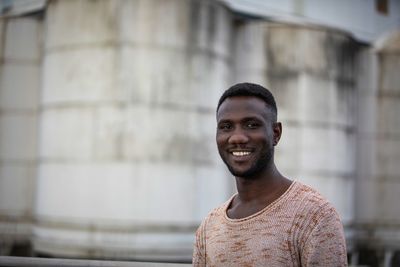 Portrait of young man while standing outdoors