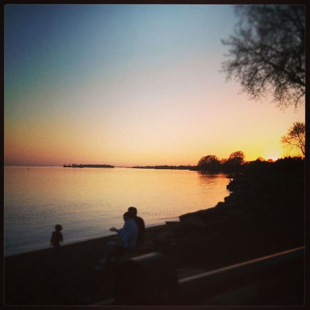 water, clear sky, sunset, transfer print, silhouette, scenics, tranquil scene, tranquility, copy space, lifestyles, beauty in nature, men, leisure activity, lake, nature, rear view, sea, auto post production filter