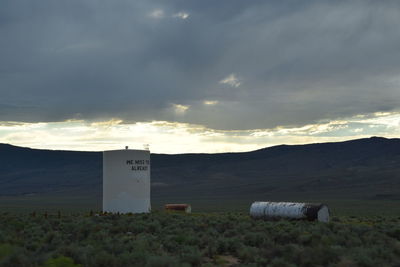 Scenic view of field against cloudy sky