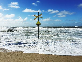 Close-up of lifeguard hut on beach against sky