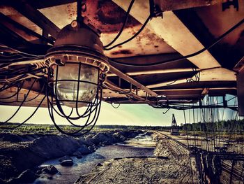 Low angle view of abandoned machinery on field