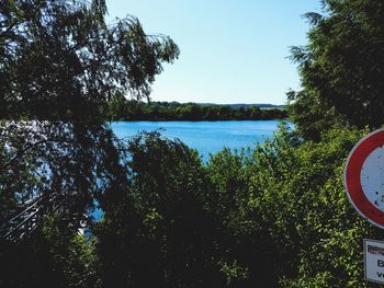 Scenic view of lake against clear blue sky