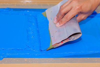 Cropped image of person screen printing