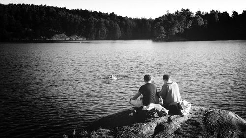 Scenic view of lake with trees in background