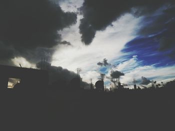 Low angle view of silhouette trees against sky