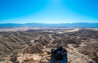 Backpack on rock at anza-borrego desert state park against clear sky