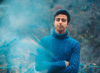 Portrait of young man standing outdoors