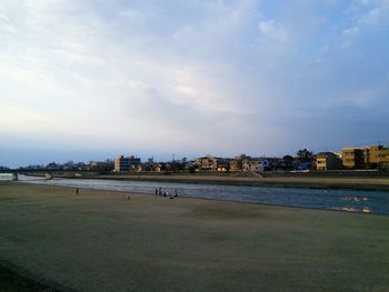 View of beach against cloudy sky