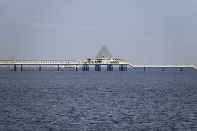 Pier over sea against clear sky