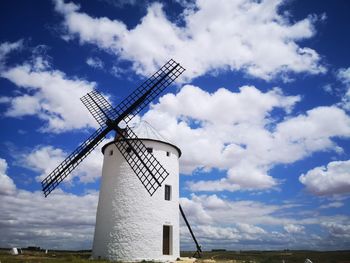 Low angle view of traditional windmill against sky