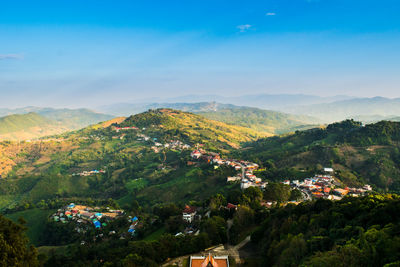 High angle view of townscape and mountains against sky