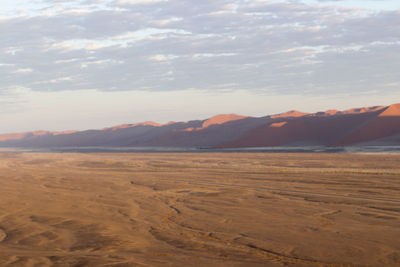 Scenic view of desert against sky during sunset