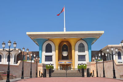 Buildings in city against clear blue sky