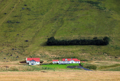 House on field against trees