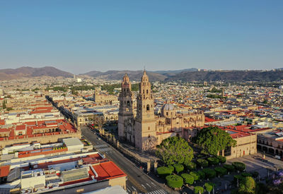 High angle view of buildings in city against clear sky