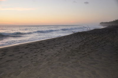 Scenic view of beach against sky during sunset