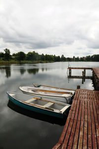 High angle view of boats moored by pier over lake
