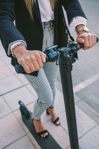 Low section of people holding bicycle